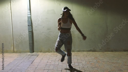 Dance, girl and hip hop dancing at night under a street light for practice, training and creative cardio movements. Teenager, dancer and active woman doing a cool performance for the urban culture