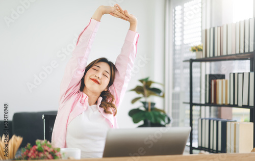 Portrait of young adult southeast business asian woman stretching hand for relax break time at home office