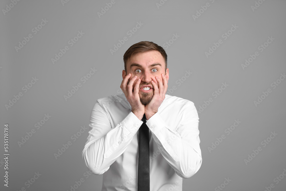 Portrait of emotional businessman on light grey background. Personality concept Portrait of emotional businessman on light grey background. Personality concept