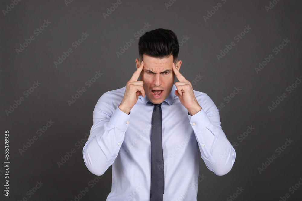 Portrait of emotional businessman on dark grey background. Personality concept Portrait of emotional businessman on dark grey background. Personality concept
