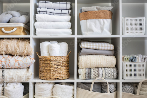 Bed linens closet neatly arrangement on shelves with copy space domestic textile Nordic minimalism photo