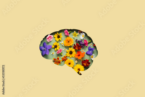 Paper cut brain and flowers on yellow background. Mental health concept