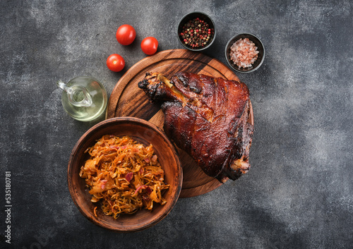Canvas Print Smoked ham hock with stewed cabbage and spices. Baked Eisbein.