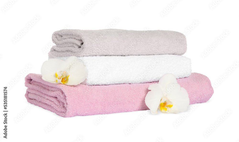 Stack of clean soft towels with orchids isolated on white Stack of clean soft towels with orchids isolated on white
