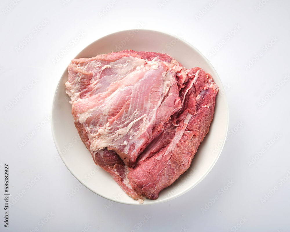 Raw Pork Shoulder Square Cut on white plate. Raw Pork Shoulder Square Cut on white plate.