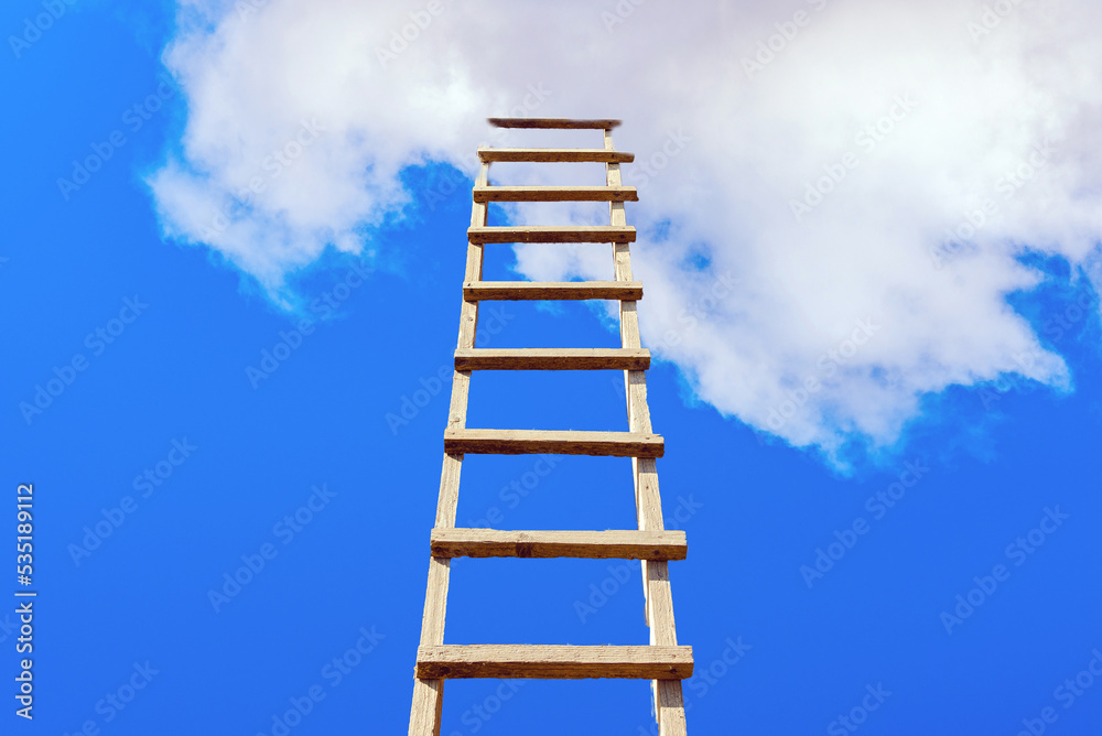 The way to success concept.Wooden ladder leading high up to the heaven.Blue sky and white clouds, success concept.Copy space. The way to success concept.Wooden ladder leading high up to the heaven.Blue sky and white clouds, success concept.Copy space.
