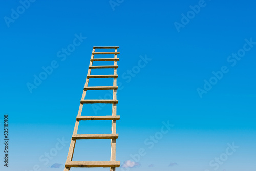 Development  Attainment  Motivation. Career Growth Concept.Wooden Ladder Leading To A Blue Bright Sky.Copy space.