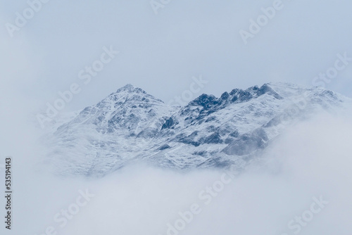Snow on the top of the Alps Innsbruck, surrounded by a cold sea of mist.