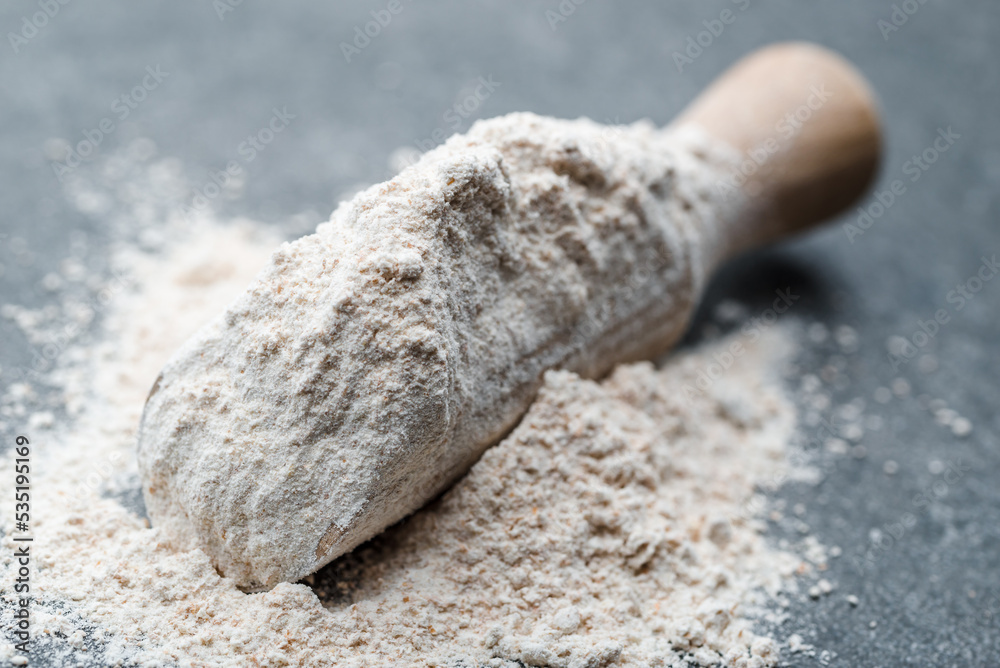 Baking background with flour on dark table Baking background with flour on dark table