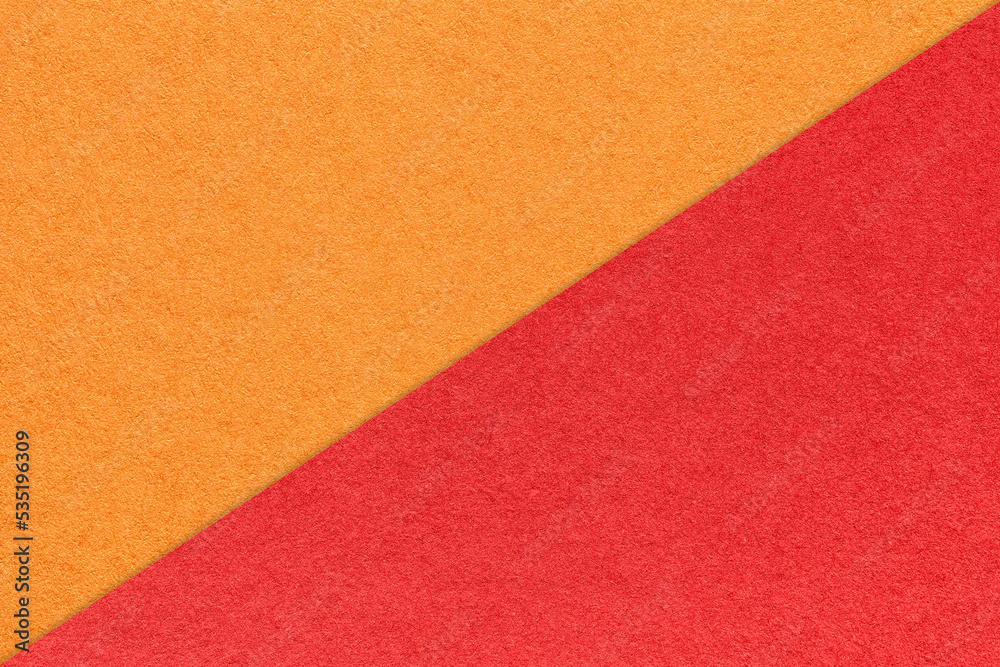 Texture of craft bright orange and red paper background, half two colors, macro. Vintage dense kraft ruby cardboard. Texture of craft bright orange and red paper background, half two colors, macro. Vintage dense kraft ruby cardboard.