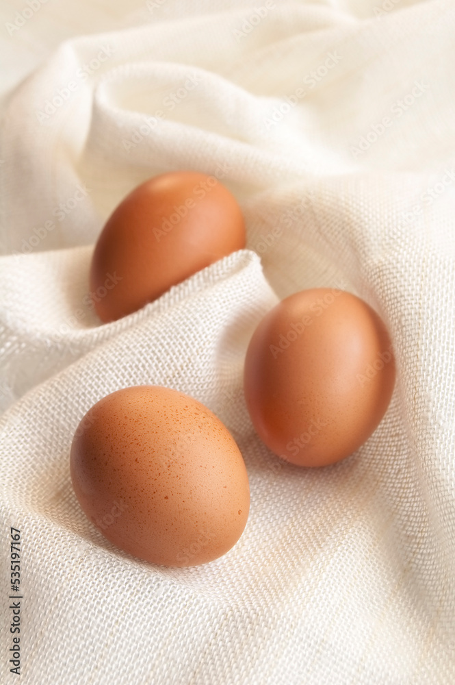 The three eggs on the white cloth background The three eggs on the white cloth background