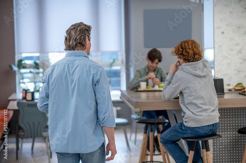 Teacher talking with his pupils during lunch time