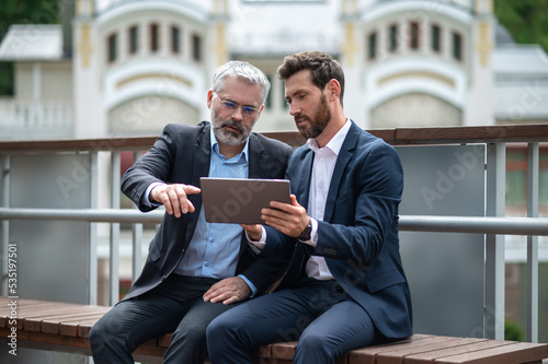 Two businessmen negotioating regarding new property and looking interested