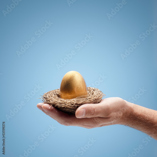 Canvastavla Retirement savings pension golden nest egg in a mans hand
