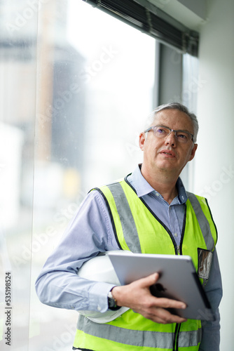 Professional senior engineer builder old man work looking at contract detail document paper