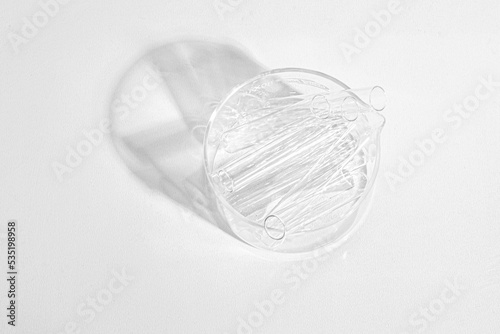 Laboratory equipment with advertising backgrounds. Medical flasks, bowls. Chemical laboratory research of cosmetics. Serums for the face.