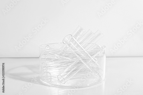 Laboratory equipment with advertising backgrounds. Medical flasks, bowls. Chemical laboratory research of cosmetics. Serums for the face.