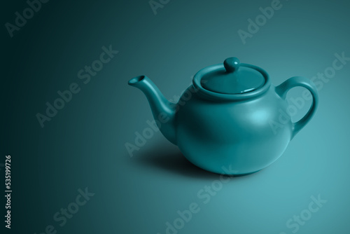 green tea pot on some colored background