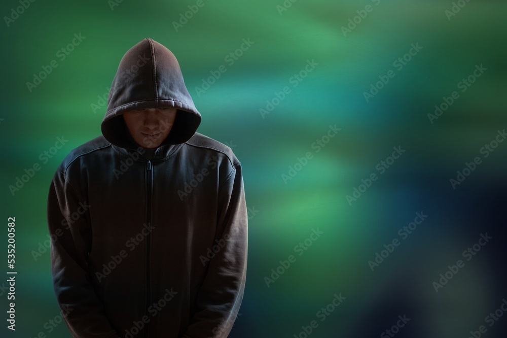 Brutal man looking under a black hood. People security concept.