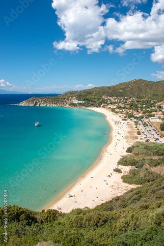 Fototapeta Naklejka Na Ścianę i Meble -  Aerial view on the beach Solanas with white sand, hills with green vegetation, sea with blue transparent water and village in the province Sinnai. Location Sardinia, Italy.
