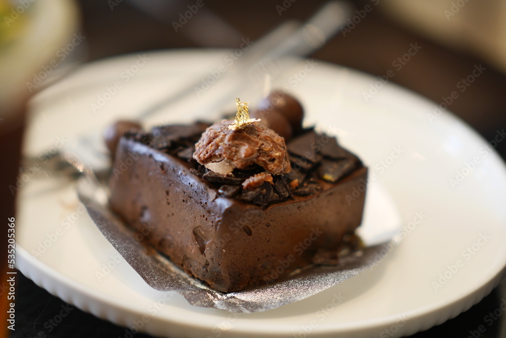 Piece of Bakery butter Cake Cream ferrero chocolate Flavor on white dish. Piece of Bakery butter Cake Cream ferrero chocolate Flavor on white dish.