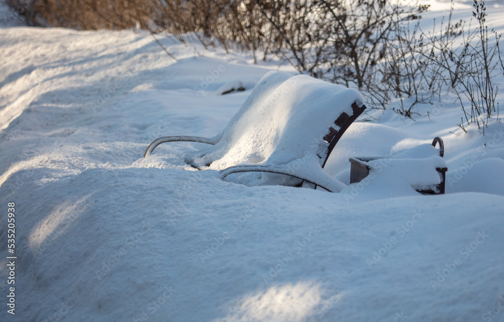 Bench in the snow in the park. Bench in the snow in the park.