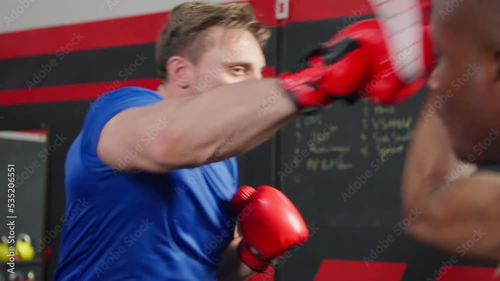 African american fitness trainer support sportsman doing boxing in gym. African american fitness trainer support sportsman doing boxing in gym.