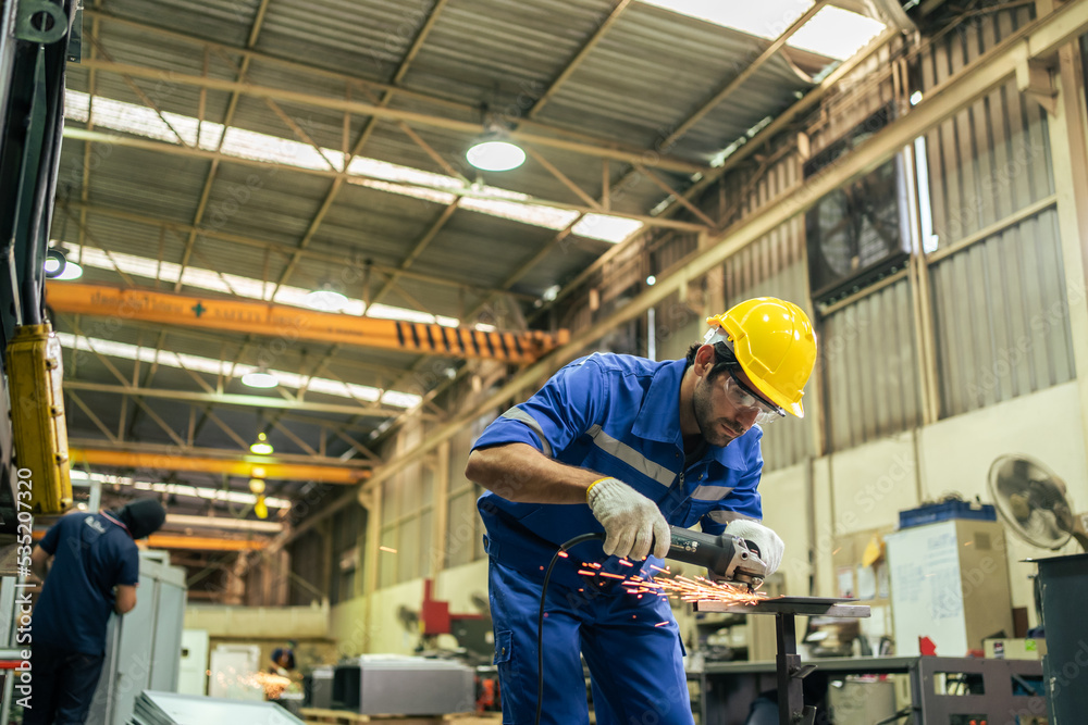 Caucasian handsome male industrial worker work in manufacturing plant.