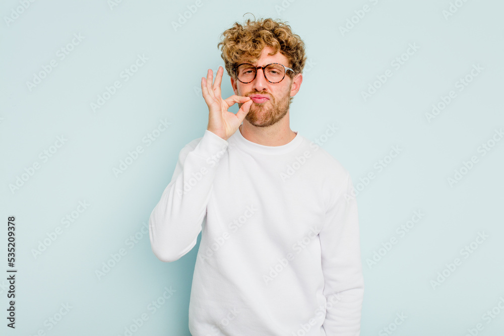 Young caucasian man isolated on blue background with fingers on lips keeping a secret. Young caucasian man isolated on blue background with fingers on lips keeping a secret.