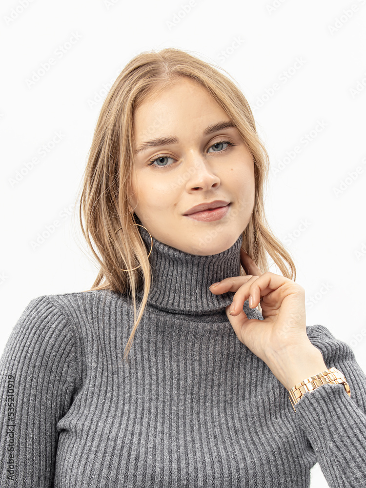 Woman in grey knitted turtleneck on white background. Soft high collar Woman in grey knitted turtleneck on white background. Soft high collar