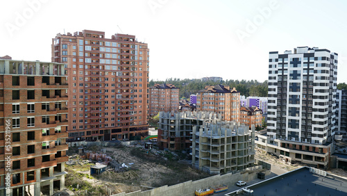 View from a height of the construction site, modern construction of new residential complexes in a small town