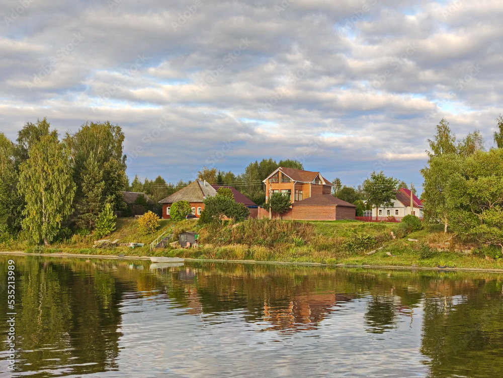 Fototapeta premium Autumn clouds over the Volga village