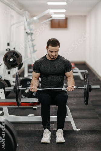 Young man trains his body to stay fit and have defined muscles.