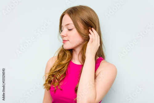 Portrait of pretty young caucasian woman isolated on blue background