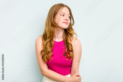 Portrait of pretty young caucasian woman isolated on blue background © Asier
