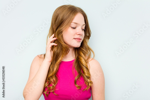 Portrait of pretty young caucasian woman isolated on blue background