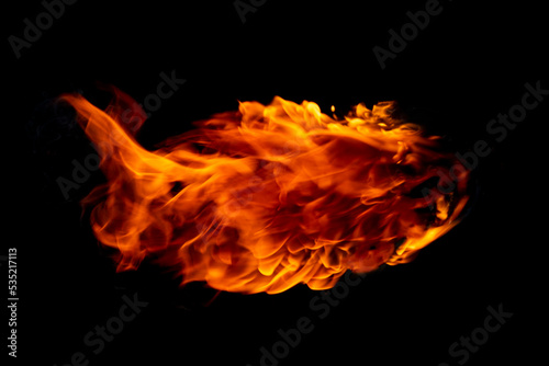 Flame of burning fire going through a black background