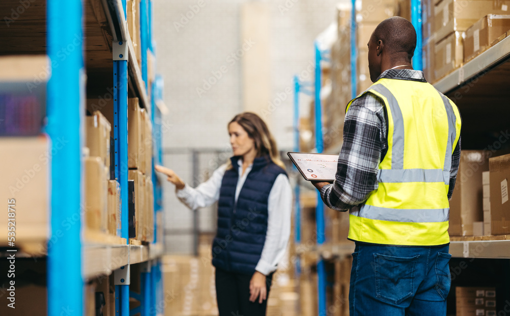 Warehouse staff using warehouse management software in a fulfillment center Warehouse staff using warehouse management software in a fulfillment center