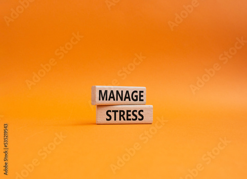 Manage stress symbol. Concept word Manage stress on wooden blocks. Beautiful orange background. Business and Manage stress concept. Copy space