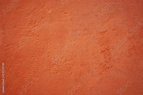 Orange textured background from italian house wall close up.