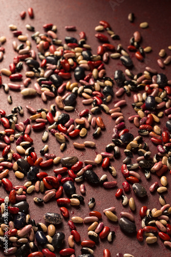 burgundy background with scattered beans