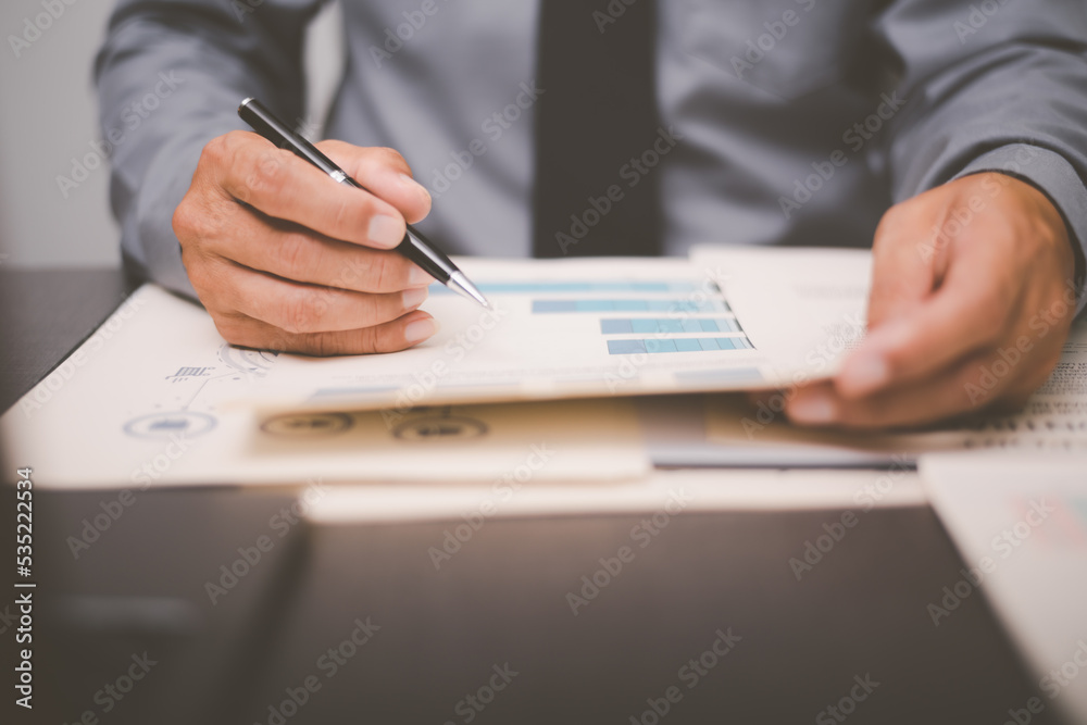 Businessman validates and manages business documents and agreements. , signing a business contract approval of contract documents confirmation or warranty certificate,employment idea, project review Businessman validates and manages business documents and agreements. , signing a business contract approval of contract documents confirmation or warranty certificate,employment idea, project review