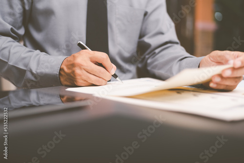 Businessman validates and manages business documents and agreements. , signing a business contract approval of contract documents confirmation or warranty certificate,employment idea, project review photo
