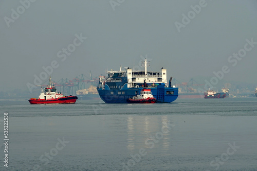 Tugboat and transportation ship maneuver in Tanjung Perak port, Surabaya, Indonesia, August 2022