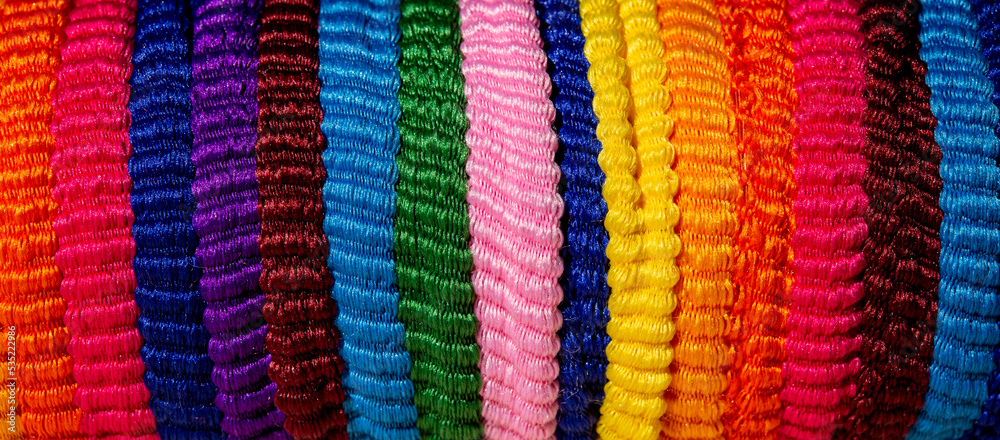 Closeup of colourful fabric threads making abstract background.