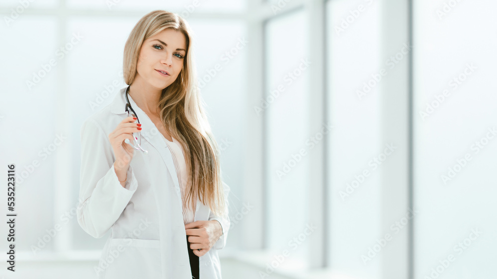 confident female therapist standing by the office window