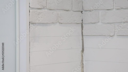 laying decorative embossed gypsum bricks on the wall. Modern apartment renovation photo