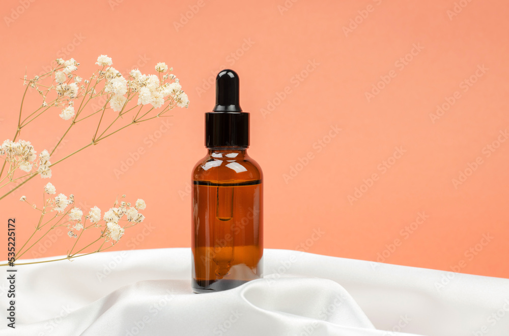 Mockup of an amber glass bottle with a pipette. Natural cosmetics for body care. Mockup of an amber glass bottle with a pipette. Natural cosmetics for body care.