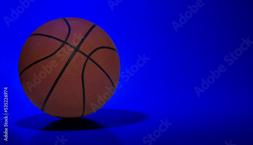 Basket ball on blue light abstract background with copy space © stockyme