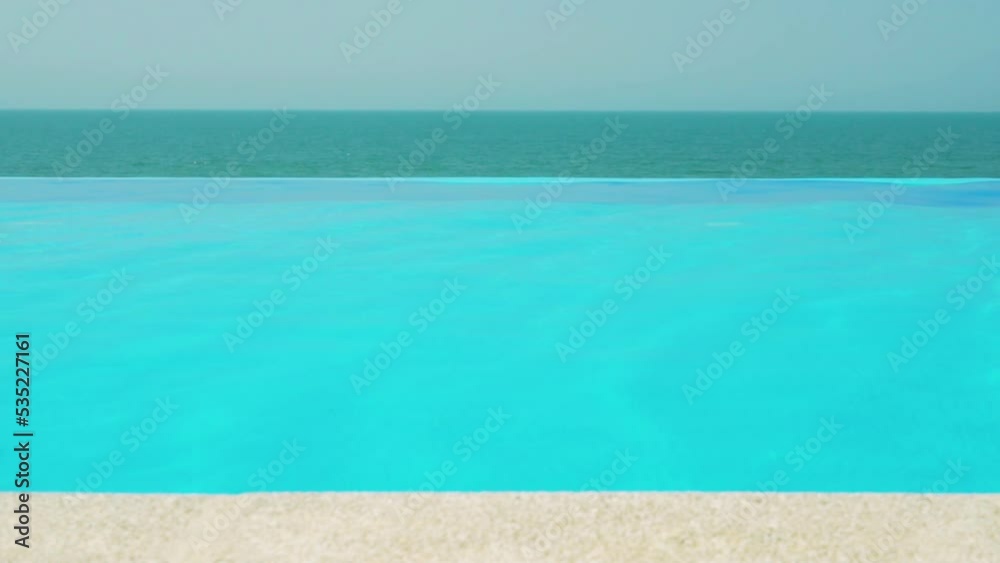 Outdoor Infinity Swimming Pool with Clear Blue Turquoise Water at Resort Beach Villa with Sea View on a Sunny Summer Afternoon. Luxury Vacation Background, Calm, Rest.